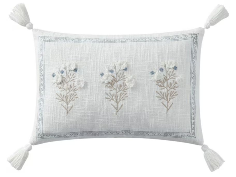 A blue and cream embroidered pillow