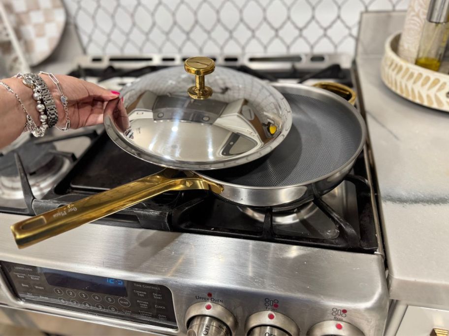 A pan with a lid on a gas stove