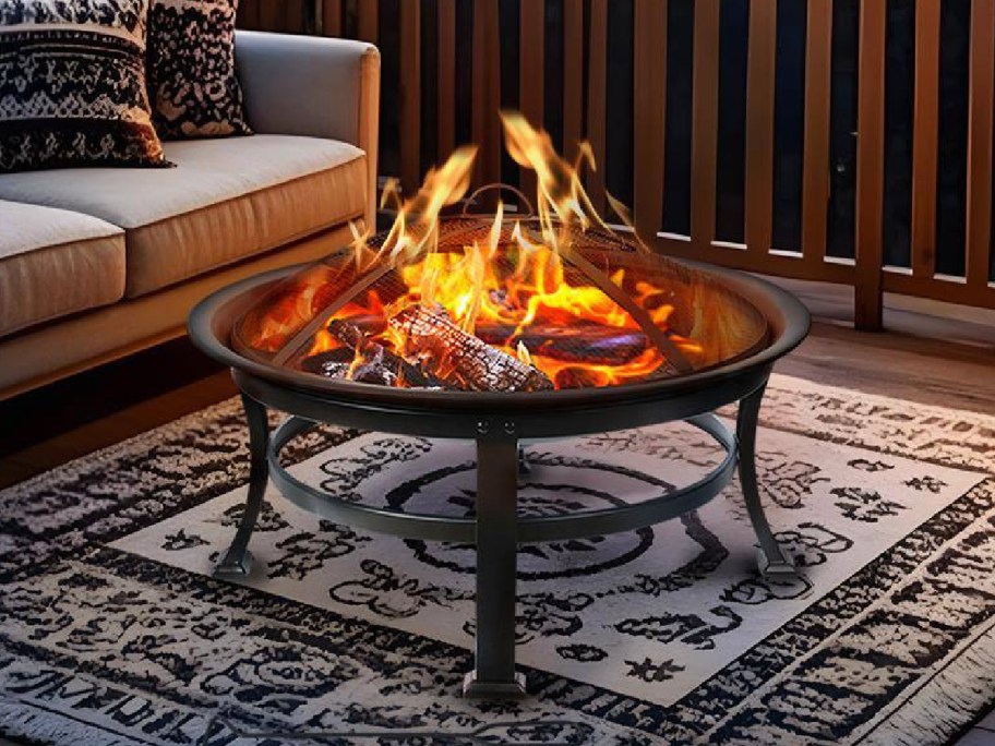 Outdoor Wood Burning Fire Pit displayed on a rug