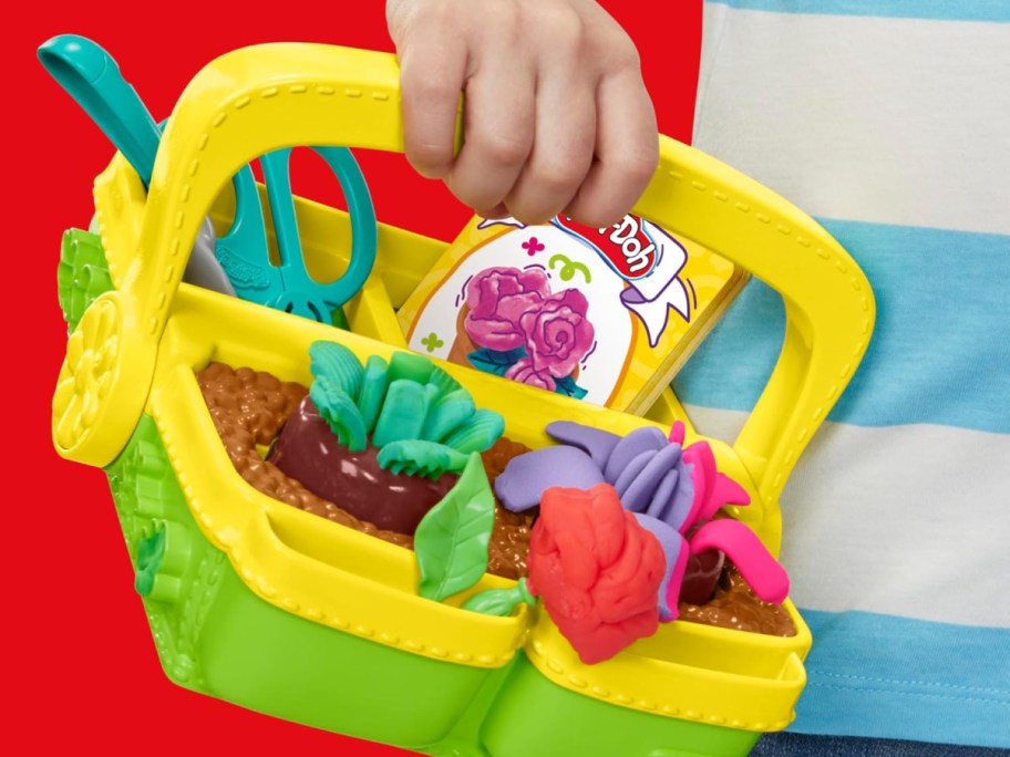 Play-Doh Blooming Flower Garden Playset in little boys hand