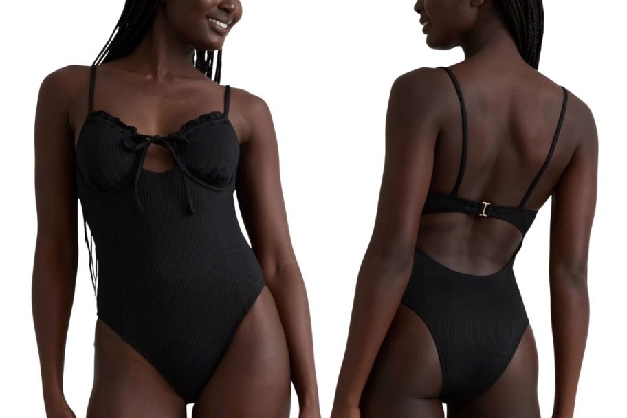 a model in black 1 piece swimsuit