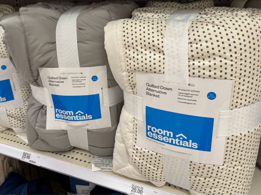 Several down alternative blankets on a shelf