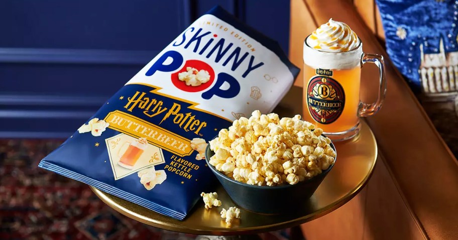 bag and bowl of SkinnyPop ButterBeer Flavored Kettle Popcorn next to mug of ButterBeer