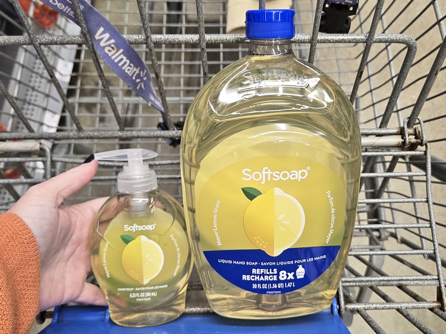 hand holding a bottle of Softsoap Meyer Lemon hand soap in cart next to large refill bottle