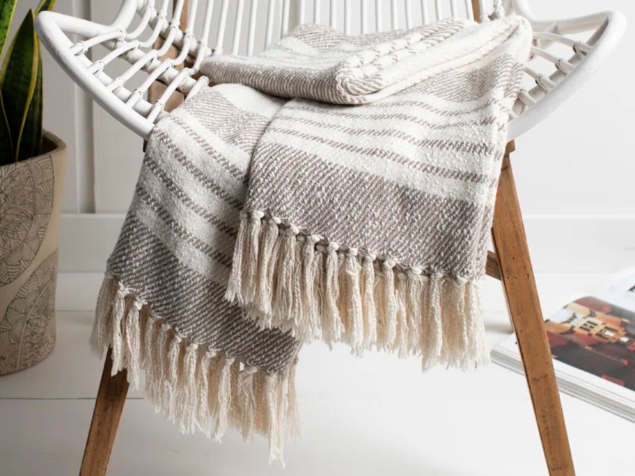 gray and white stripe throw blanket on accent chair