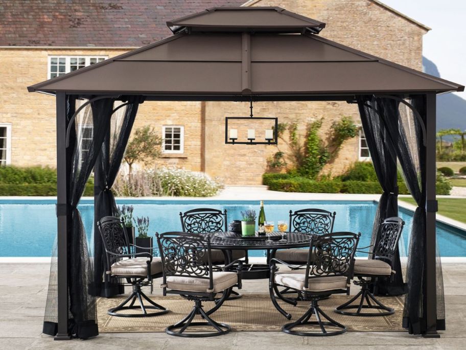 A hard-top gazebo near a pool