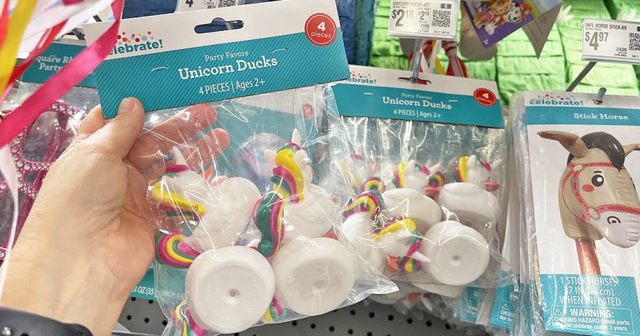 hand holding up a 4-pack of unicorn rubber ducks in store