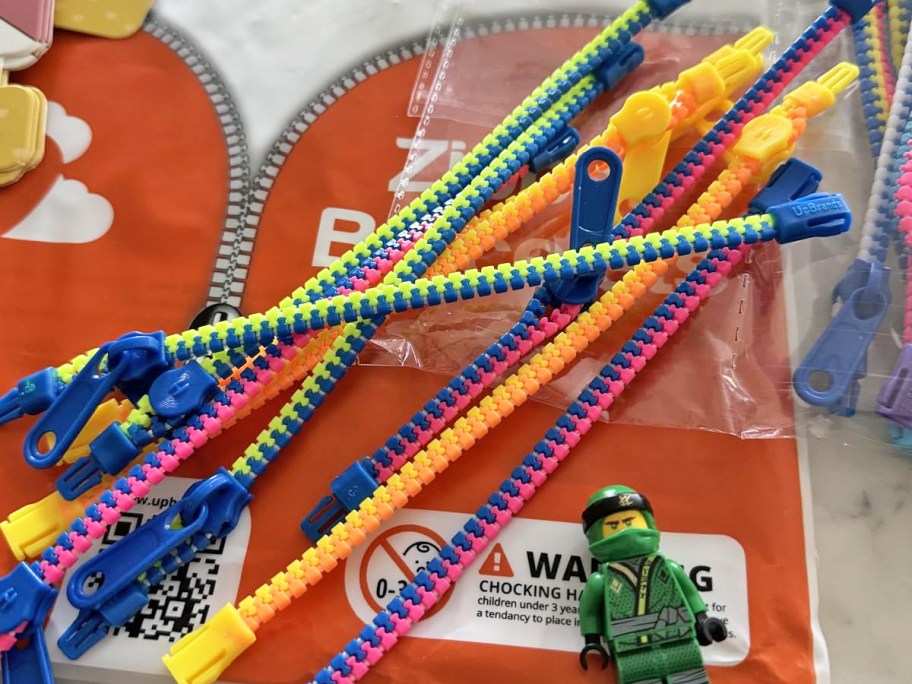 multiple colorful zipper bracelets on top of plastic packaging