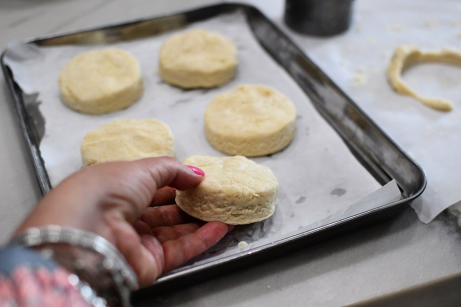 adding biscuits to a sheet pan 