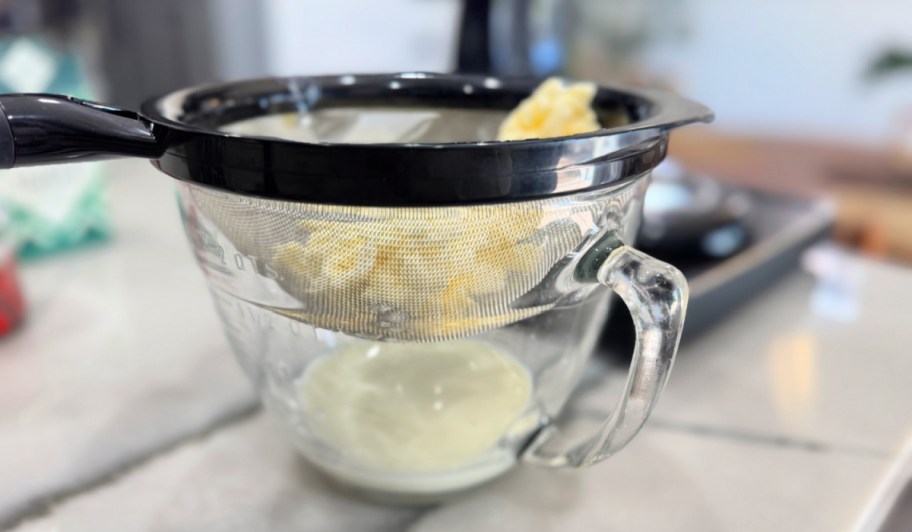 adding butter to a mesh strainer