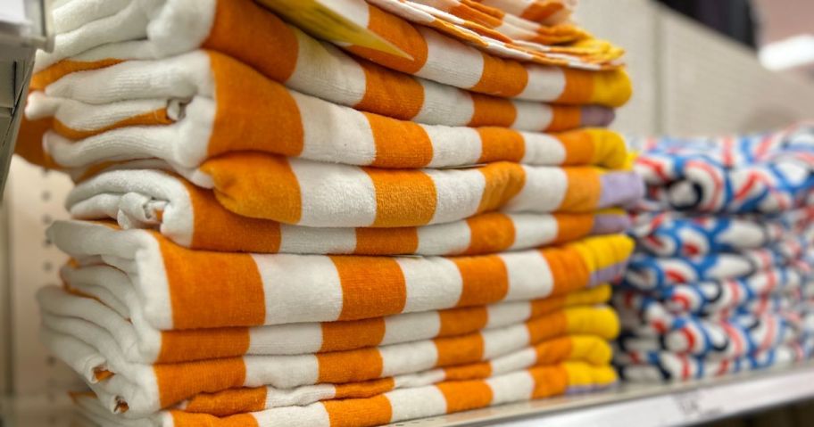 beach towels stacked on shelf in store