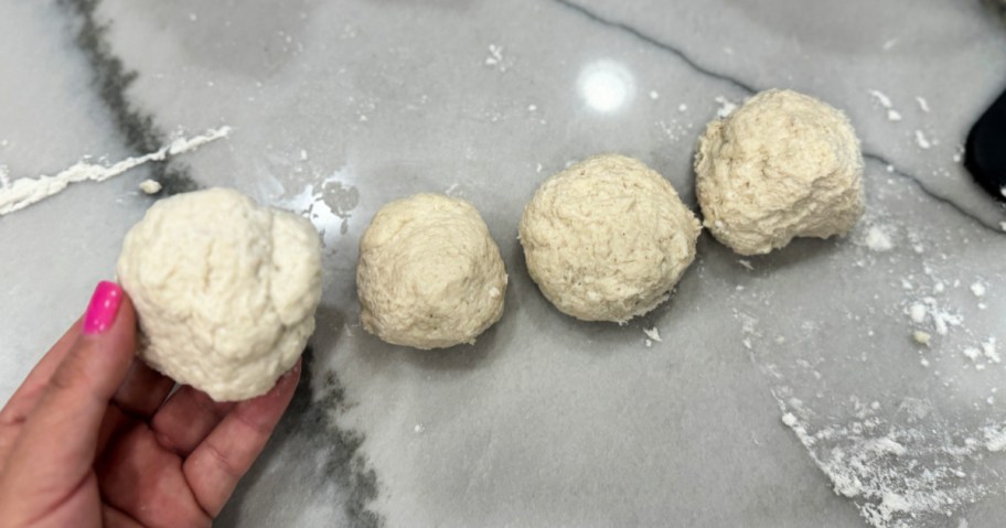 breaking up dough in four balls