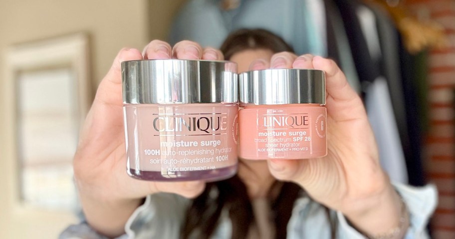 woman holding two clinique moisture surge jars 