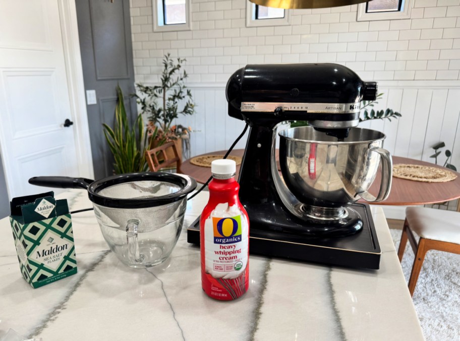 cream and a stand mixer on the kitchen counter ready to make butter 