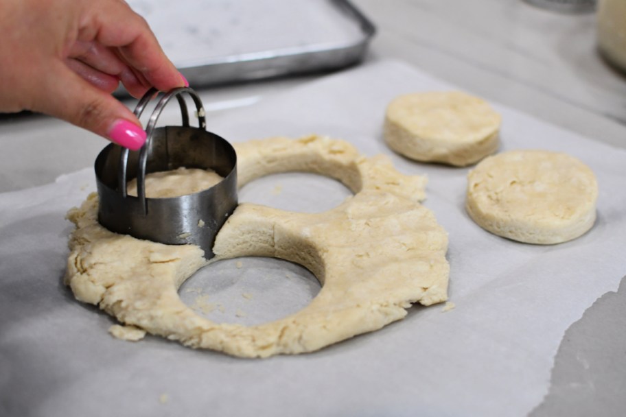 cutting out biscuits from sourdough biscuit dough 