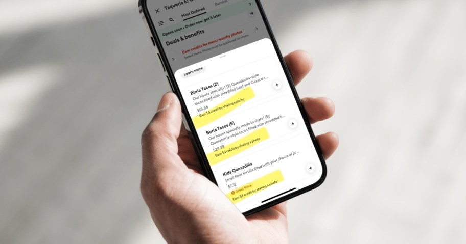 hand holding phone with doordash credit offers