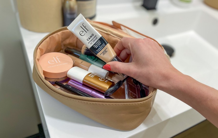 hand pulling elf makeup out of cosmetic bag