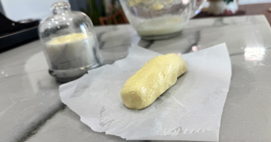 homemade butter in a dish and in parchment paper