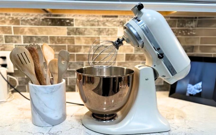 a 5-quart KitchenAid stand mixer in matte fresh linen with copper coated bowl