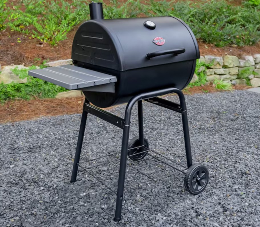 black charcoal grill with wheels outside