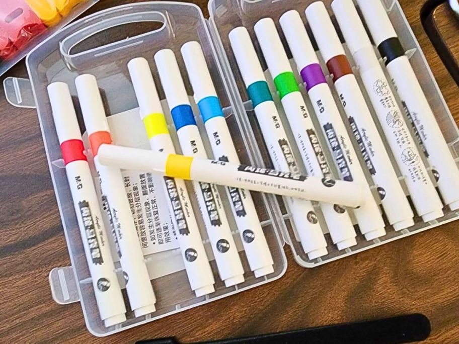 a Acrylic Paint Pens 12-Count in case on table