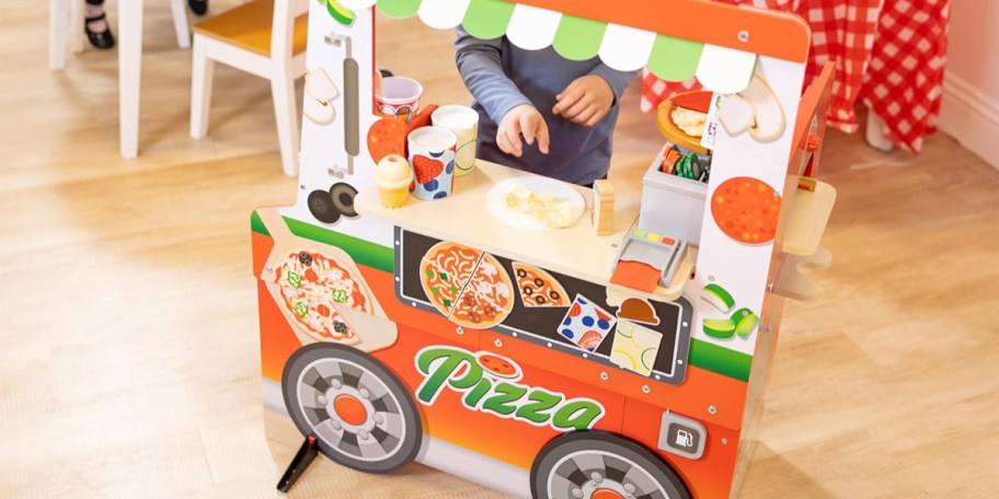 kid playing with wooden pizza food truck toy