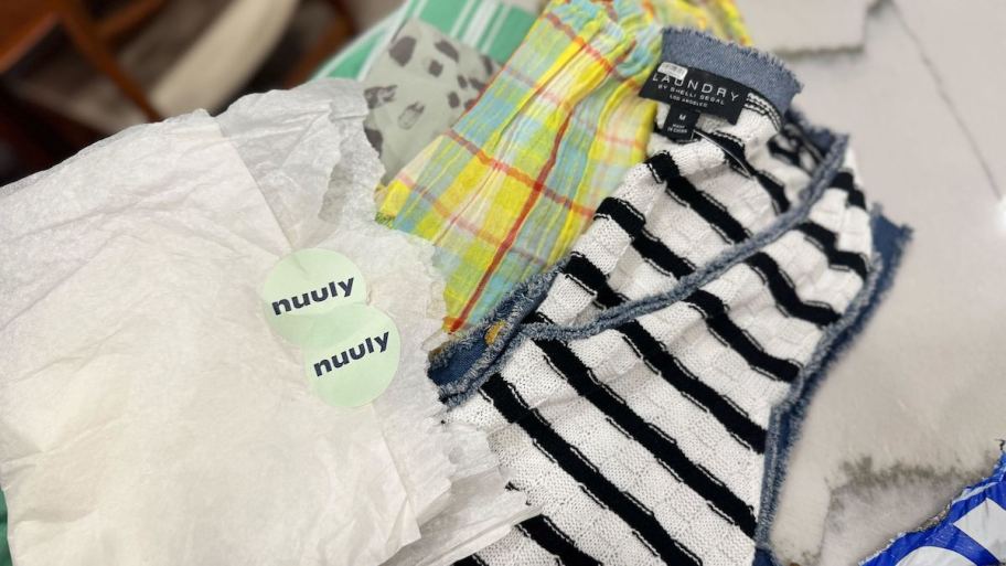 clothes and tissue paper with nuuly resale stickers