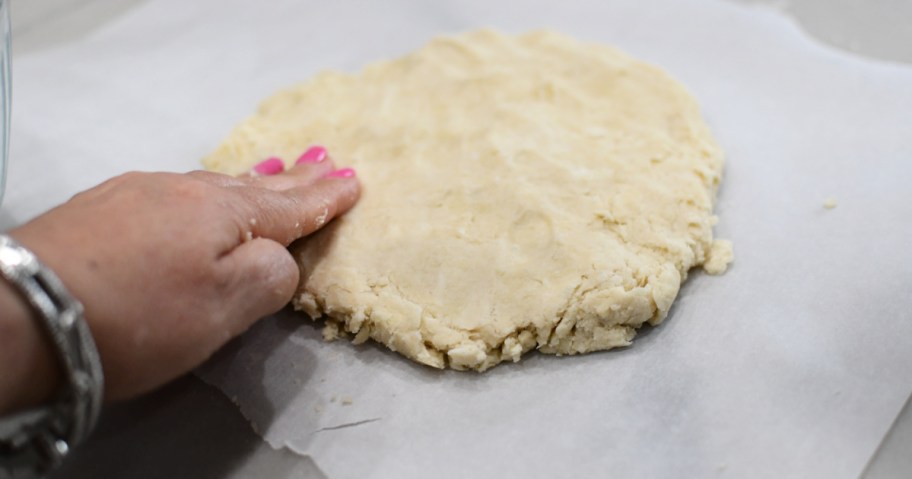 pressing biscuit dough 