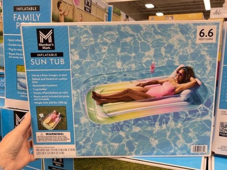 Member's Mark Inflatable Sun Tub Tanning Pool Float box in hand in store