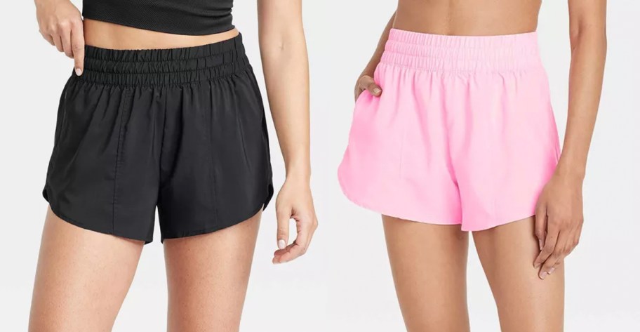 two women wearing black and pink shorts 
