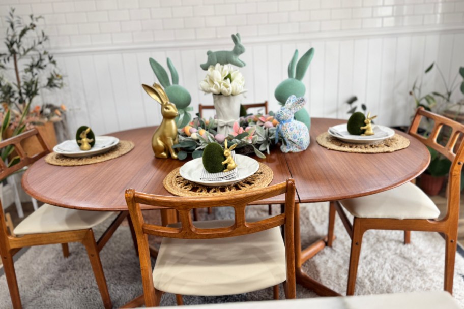 round table with two flocked bunnies and easter decor in center