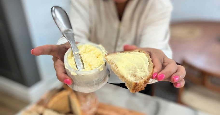 woman holding homemade butter and a slice of bread 