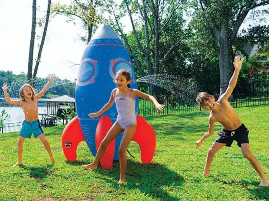 Kids playing outside with a BigMouth 7' Outdoor Giant Rocket Sprinkler