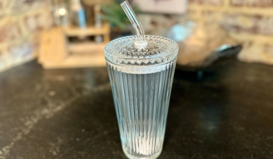 better homes & gardens glass tumbler with lid and straw on countertop