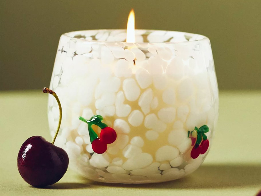white bubble glass candle with mini cherries on the sides