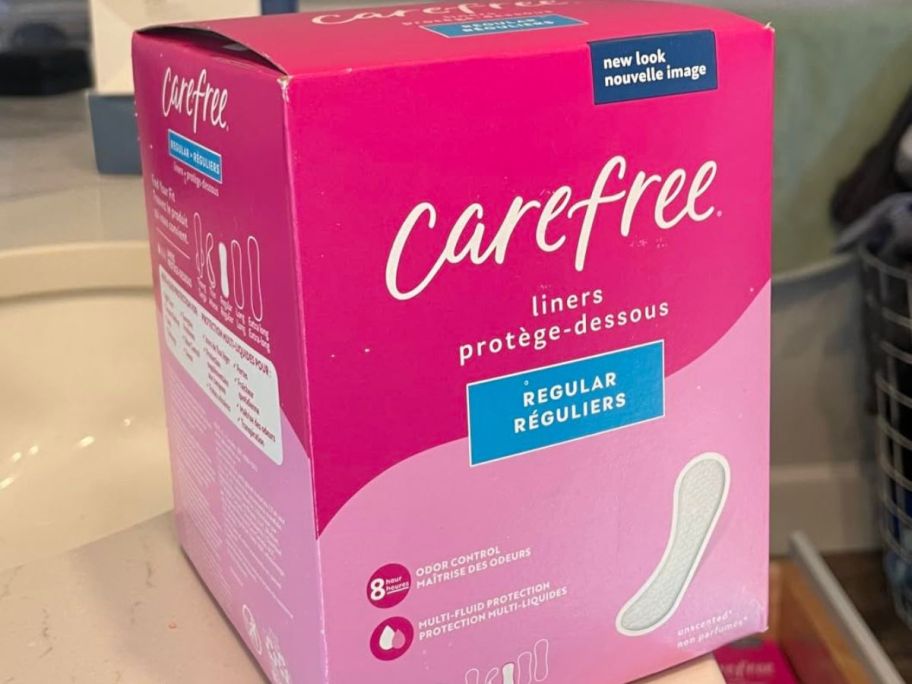 A box of Carefree pads in a bathroom