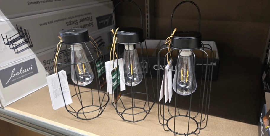 three different style lanterns displayed on a table