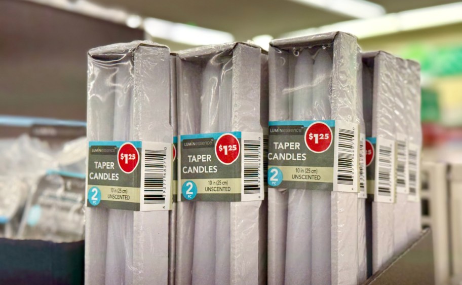 packages of taper candles on display at dollar tree