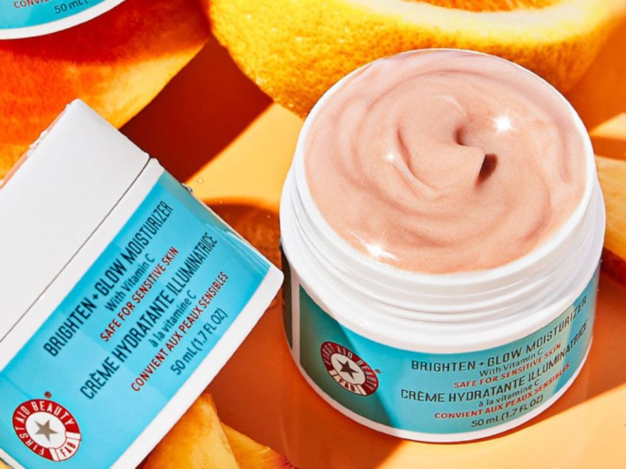 An open jar of First Aid Beauty Brighten + Glow Moisturizer w/ Vitamin C 