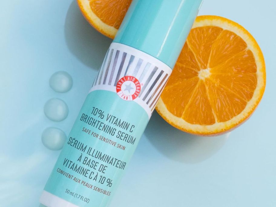 First Aid Beauty 10% Vitamin C Brightening Serum Next to fresh cut oranges
