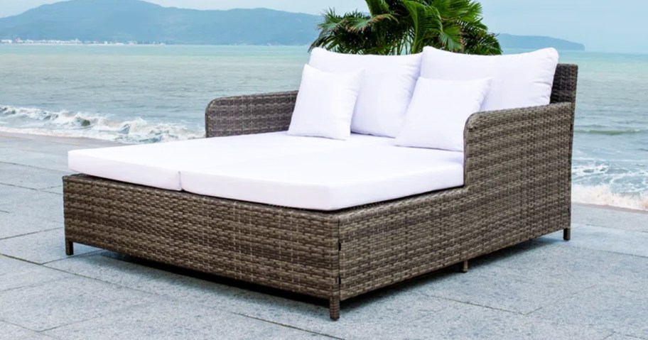 wicker patio daybed with white cushions