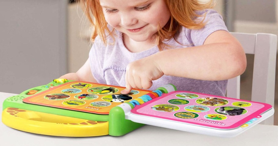 girl pressing buttons in LeapFrog 100 Animals Book