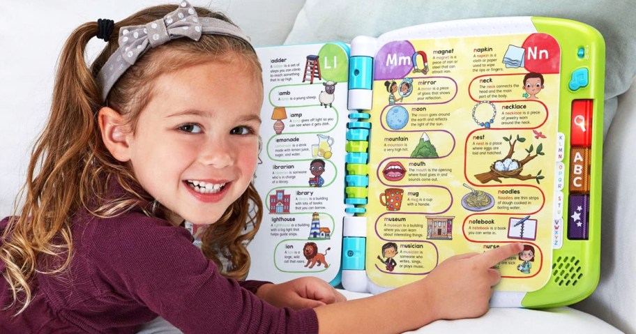 girl pointing at LeapFrog A to Z Learn with Me Dictionary