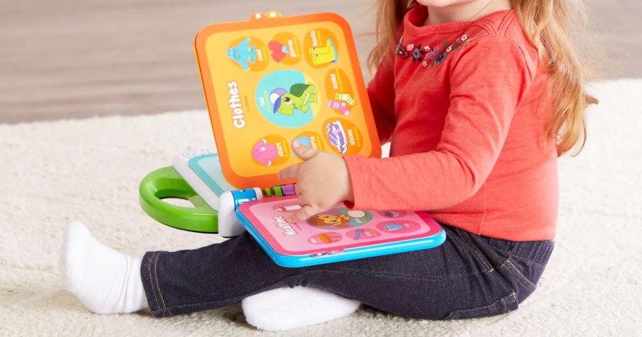 toddler turning page in LeapFrog Learning Friends 100 Words Book