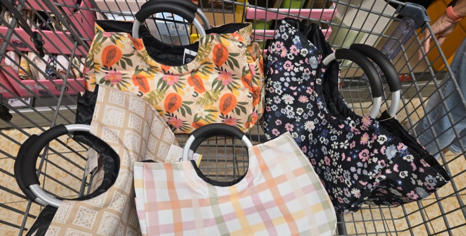 totes in different colors inside of shopping cart
