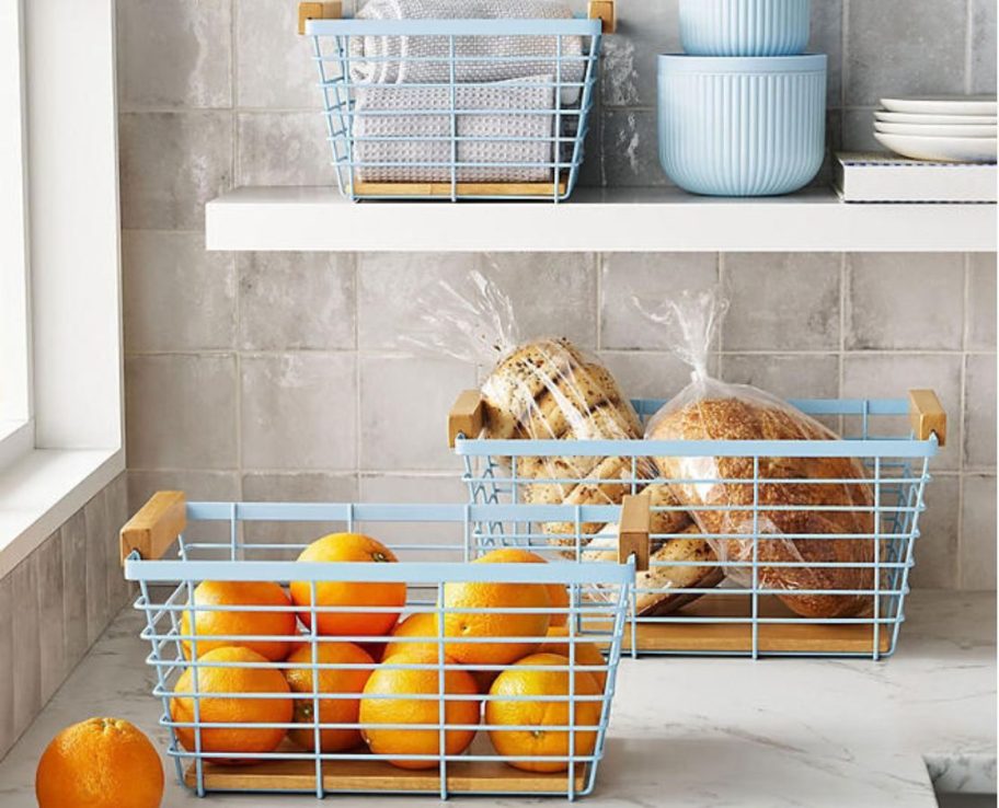 3 Member's Mark Wire Baskets on a counter and kitchen shelf