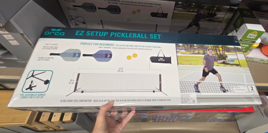 hand holding pickleball set at the store