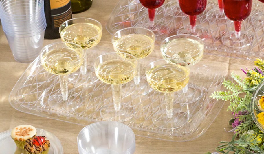 plastic champagne glasses on serving tray