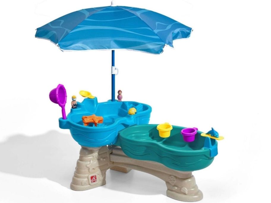 a two tier water table with umbrella