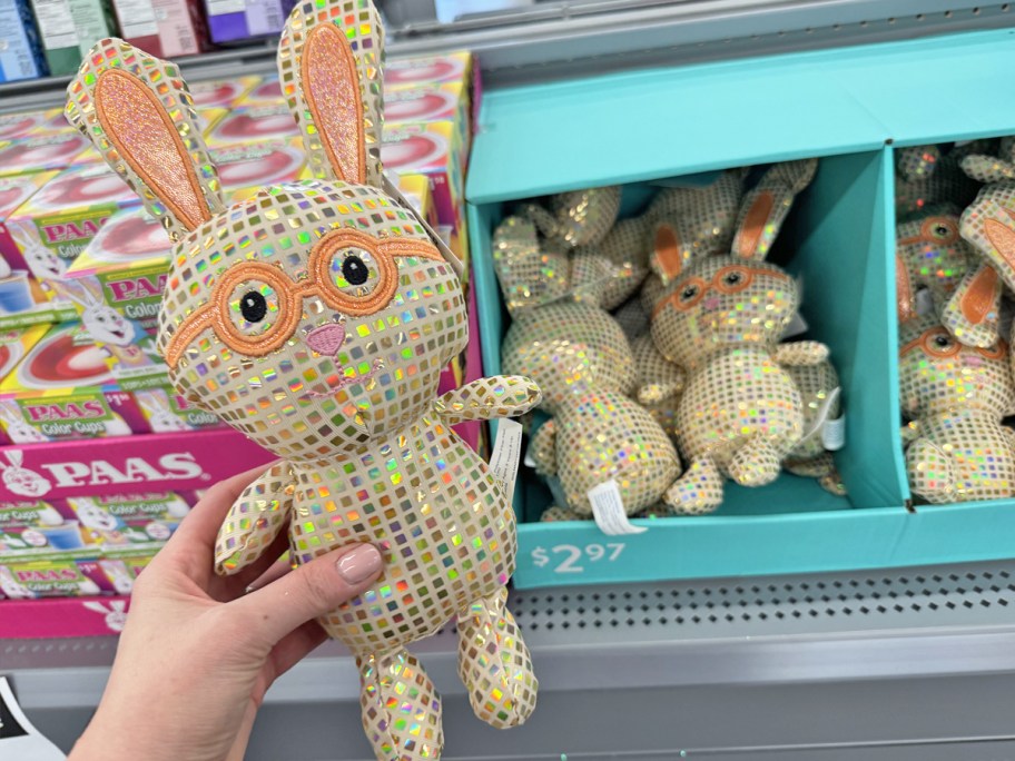 hand holding up a disco bunny plush in store